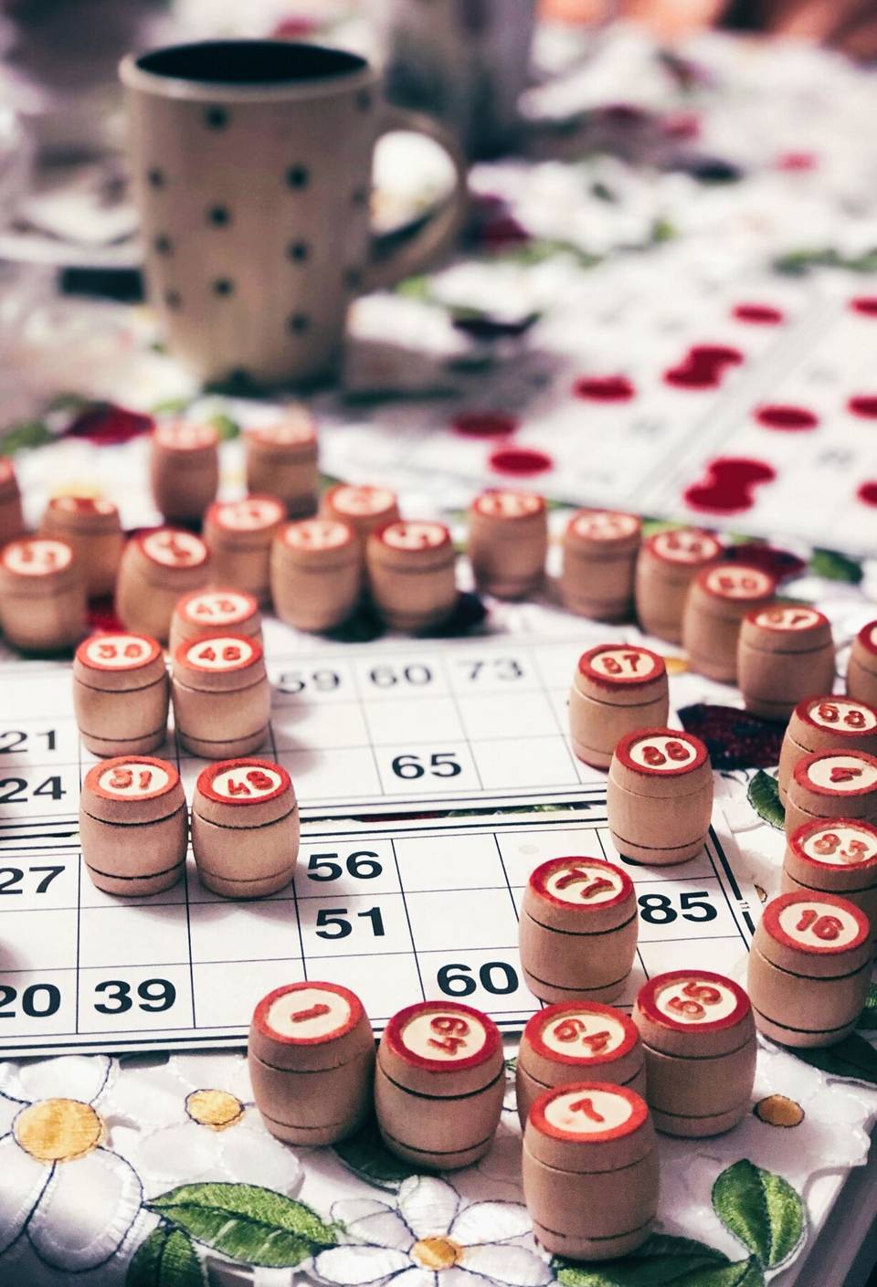 Cartões de bingo com números marcados por fichas de madeira